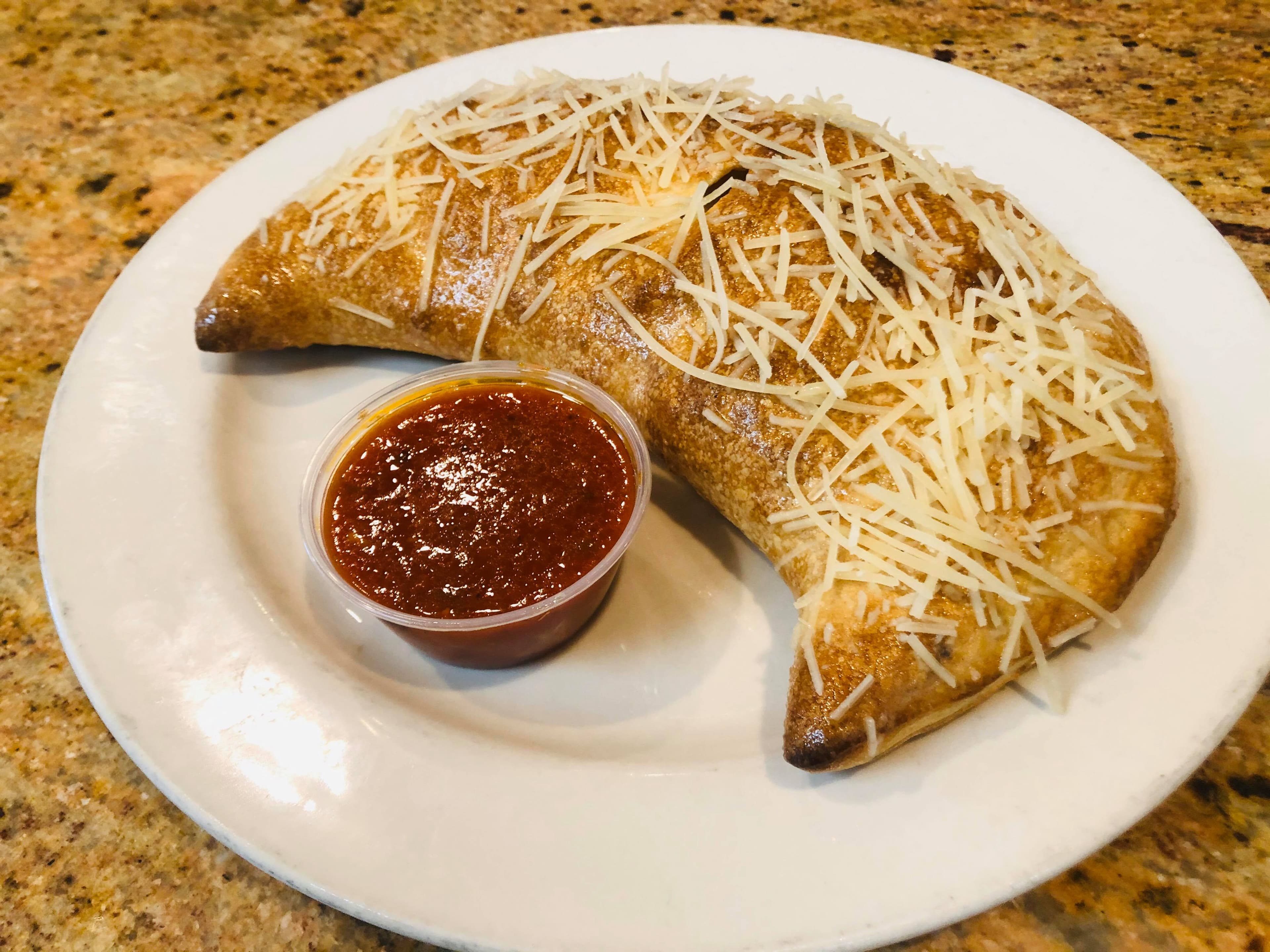 Calzone with homemade dough and shaved parmesan