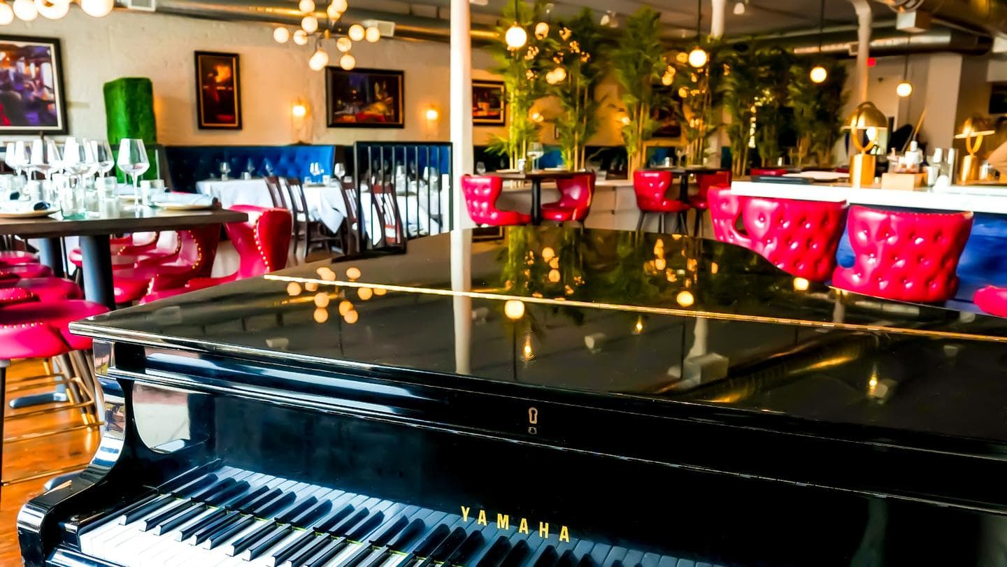 The piano and red-leather dining room